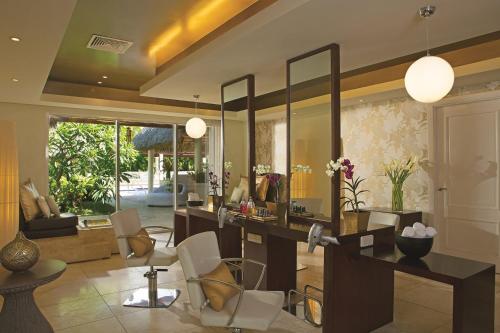 a living room with a vanity and a mirror at Secrets Royal Beach Punta Cana - Adults Only - All Inclusive in Punta Cana