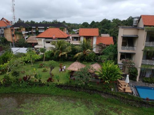 a group of people standing in the yard of a resort at Byasa Ubud in Ubud