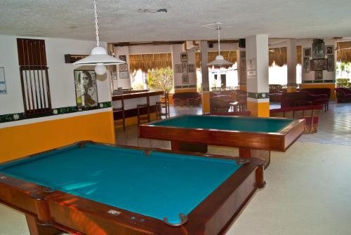 two pool tables in a room with a bar at Qualton Club Ixtapa All Inclusive in Ixtapa