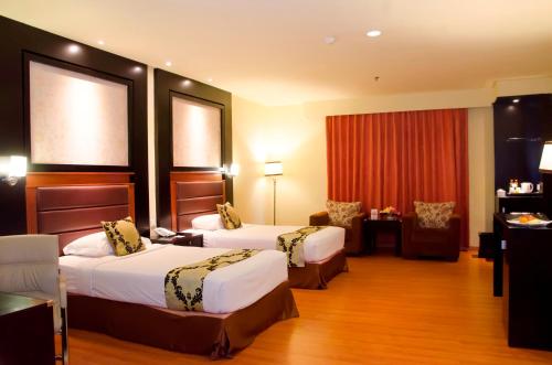 Postel nebo postele na pokoji v ubytování Sari Ater Kamboti Hotel Bandung