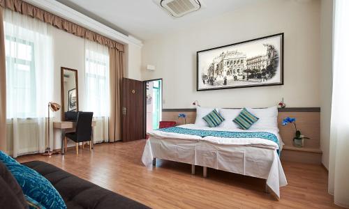 a bedroom with a bed and a couch at Lion Prémium in Budapest