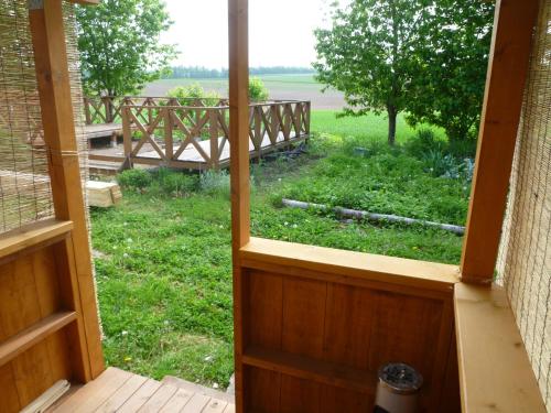 an open door to a porch with a view of a yard at Akane-yado in Nakafurano