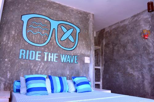 
a bed room with a blue wall and a blue wall at Cheeky Monkey Surf Camp in Weligama
