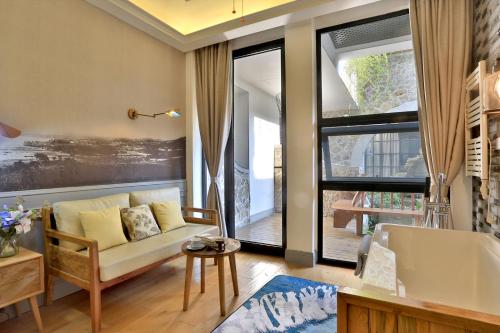 a living room with a couch and a bath tub at Youxiake Canal Hotel Hangzhou in Hangzhou