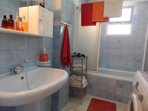 a bathroom with a sink and a tub and a shower at Albaida II 5J in Nerja