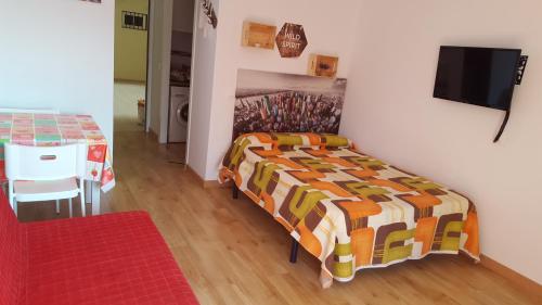 a bedroom with a bed with a colorful blanket at jp - 2.0 in Benalmádena