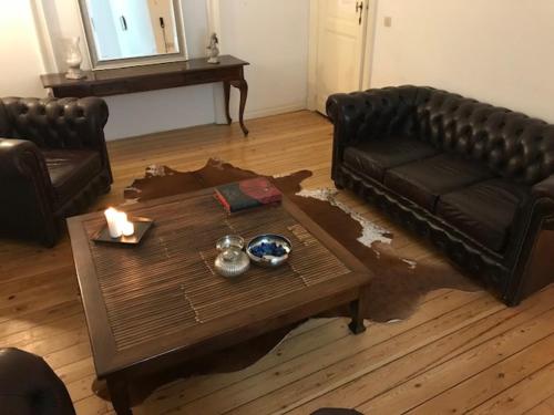 a living room with a couch and a coffee table at Chic Cocoon Guest House in Brussels