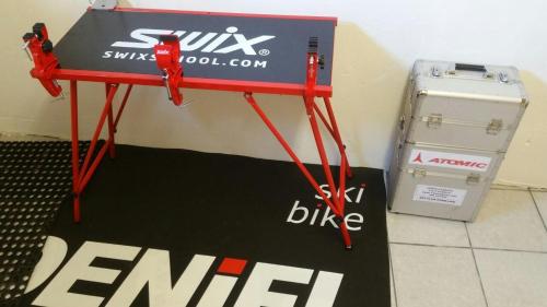 a red table with a sign on it next to a box at Ferienhaus Stubaiblick in Neustift im Stubaital