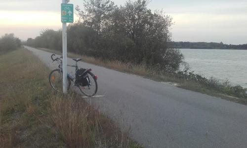 a bike parked on the side of a road next to a lake at Apartments Haus Morgensonne in Reidling