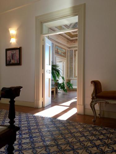 a hallway with an open door to a living room at Palazzo Suriano Heritage Hotel in Vietri sul Mare