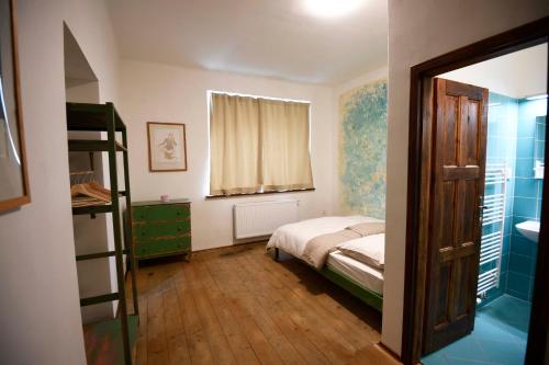 a bedroom with a bed and a ladder and a window at Giotto Apartments in Prague