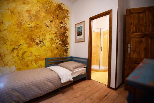 a small bedroom with a bed and a mirror at Giotto Apartments in Prague