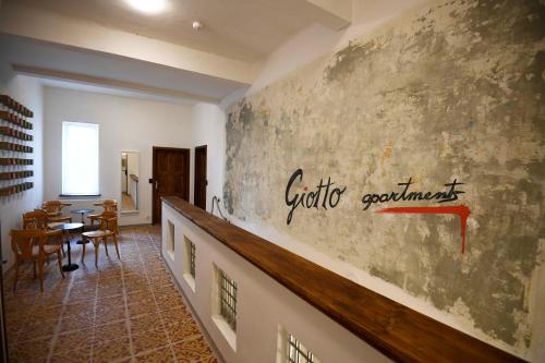 a room with a wall with writing on it at Giotto Apartments in Prague
