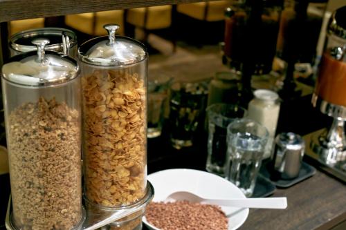 two glass containers filled with nuts on a table at City Hotel Amsterdam in Amsterdam