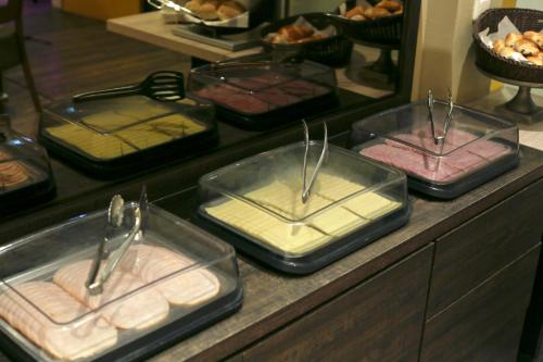 a buffet with several trays of food on a counter at City Hotel Amsterdam in Amsterdam
