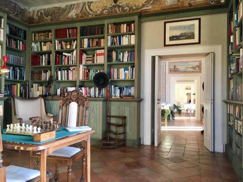 a room with a library filled with books at Palazzo Suriano Heritage Hotel in Vietri sul Mare