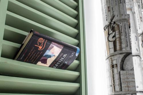 a book sitting on the side of a building at Ad Hoc Rooms in Palermo