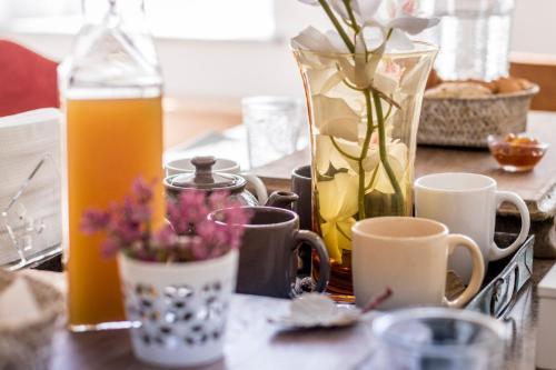 a table with flowers and a bottle of orange juice at Ad Hoc Rooms in Palermo