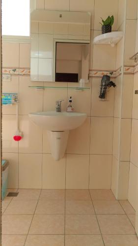 a bathroom with a sink and a mirror at Jin Xi Fu B&B in Jinning