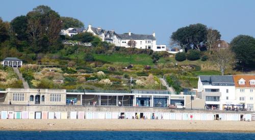 a building on a hill next to the beach at Alexandra Hotel & Restaurant in Lyme Regis