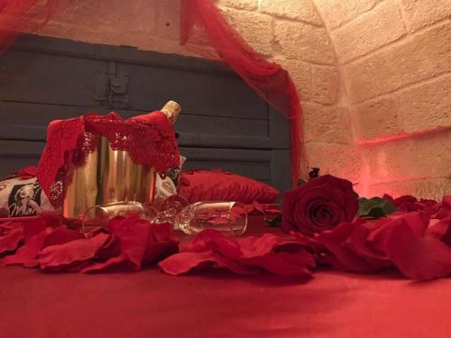 a table with red rose petals on the floor at Palazzo Savoia 1856 in Fasano