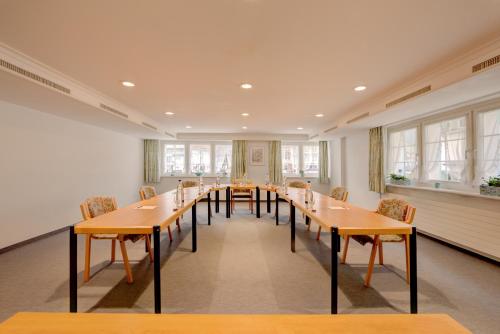 a large room with a long table and chairs at Romantik Hotel Säntis in Appenzell