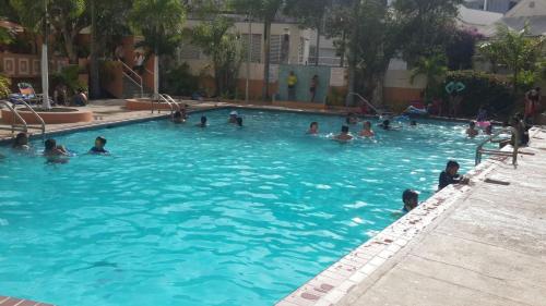 a group of people swimming in a swimming pool at Saint Tropez in San Juan