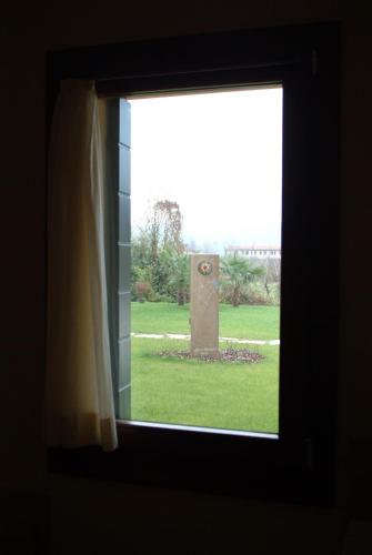 a window view of a monument in a field at Residence La Meridiana in Galzignano