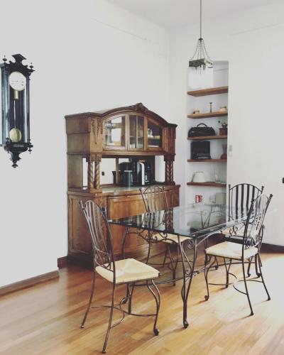 a dining room with a glass table and chairs at Cluj Apartments in Cluj-Napoca
