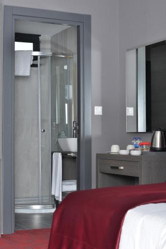 a bathroom with a shower and a sink and a bed at A11 Hotel in Istanbul