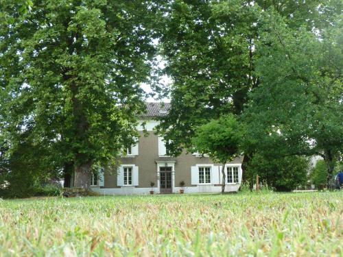 a white house with trees in front of it at Préchac Park in Préchac