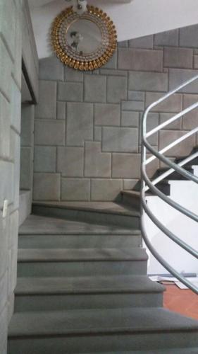 a staircase with a mirror on a brick wall at Tinoco Apart Hotel in Ayacucho