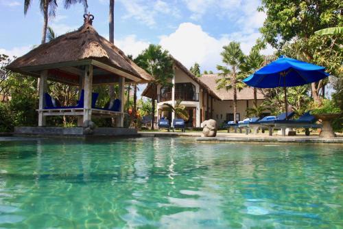 a resort with a swimming pool and a gazebo at Villa Cantik in Lovina