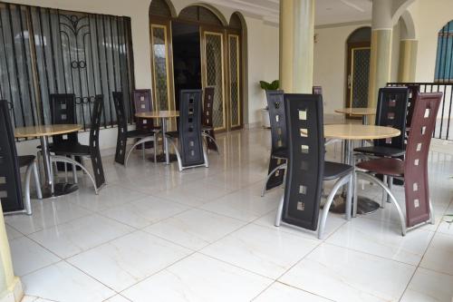 a row of tables and chairs in a restaurant at Massao Palace Hotel in Yaoundé