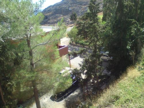 an overhead view of a river with trees and a mountain at Zefyros Studios in Damnoni