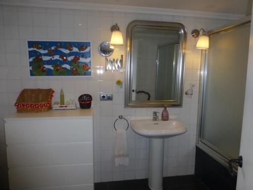 a bathroom with a sink and a mirror at Casacovas in Ferrol