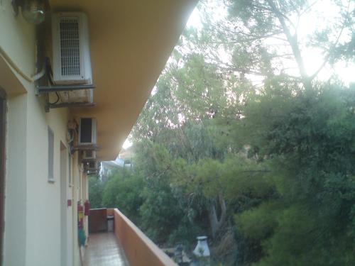 a balcony of a building with a view of a garden at Zefyros Studios in Damnoni