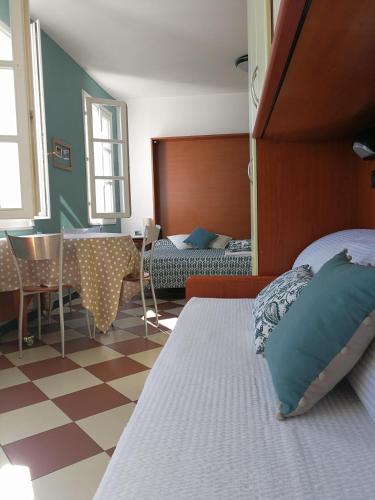 a bedroom with a bed and a table and chairs at Giada in Moneglia