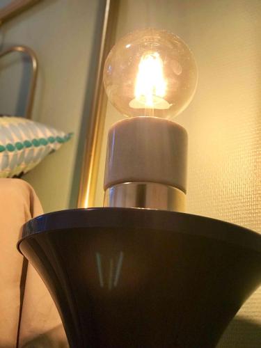 a lamp with a light on top of a table at MyAlsace in Colmar