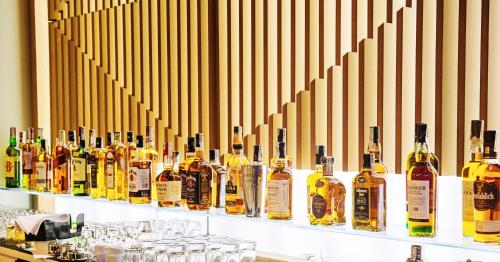 a bunch of bottles of alcohol sitting on a shelf at Hot Springs Medical and SPA in Banya