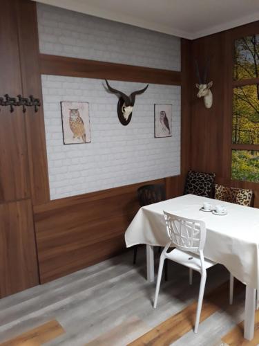 a dining room with a white table and a chair at San Cristobal in Villahermosa