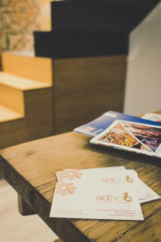 a wooden table with pamphlets on top of it at Ad Hoc Rooms in Palermo