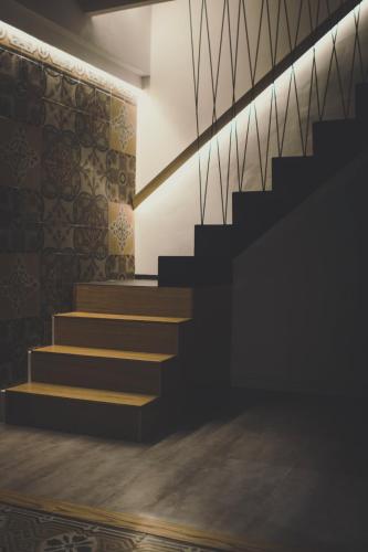 an empty room with stairs and a wall at Ad Hoc Rooms in Palermo