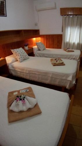 two beds in a hotel room with towels on them at Hotel Ideal in Montecarlo