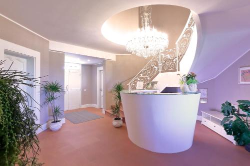 a large room with a staircase and potted plants at Agriturismo Tenuta "Il Cigno" in Villanterio