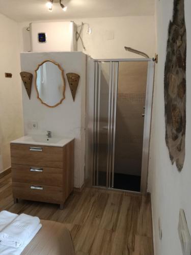 a bathroom with a shower and a sink and a mirror at La Mirilla Suites 2 in Tarifa