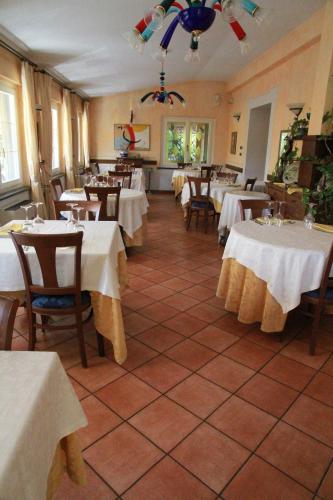 a restaurant with tables and chairs with white table cloth at Locanda Miranda in Tellaro