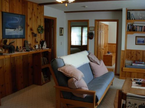 a living room with a couch and a table at Alaska Chalet Bed & Breakfast in Eagle River