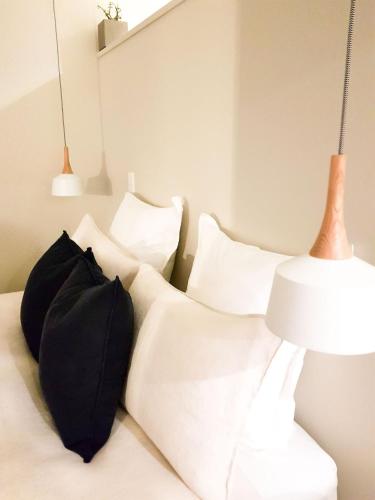 a bedroom with a bed with pillows and a lamp at WoodyHanger Lodge in Whitianga