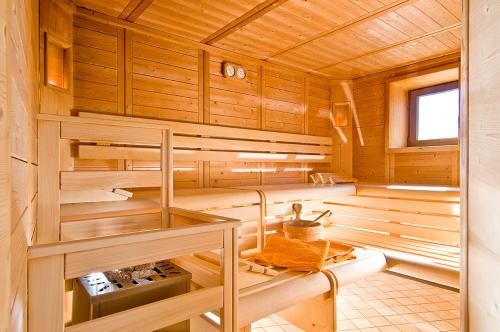 a sauna with wooden walls and wooden floors at Hotel Sonne in Stelvio